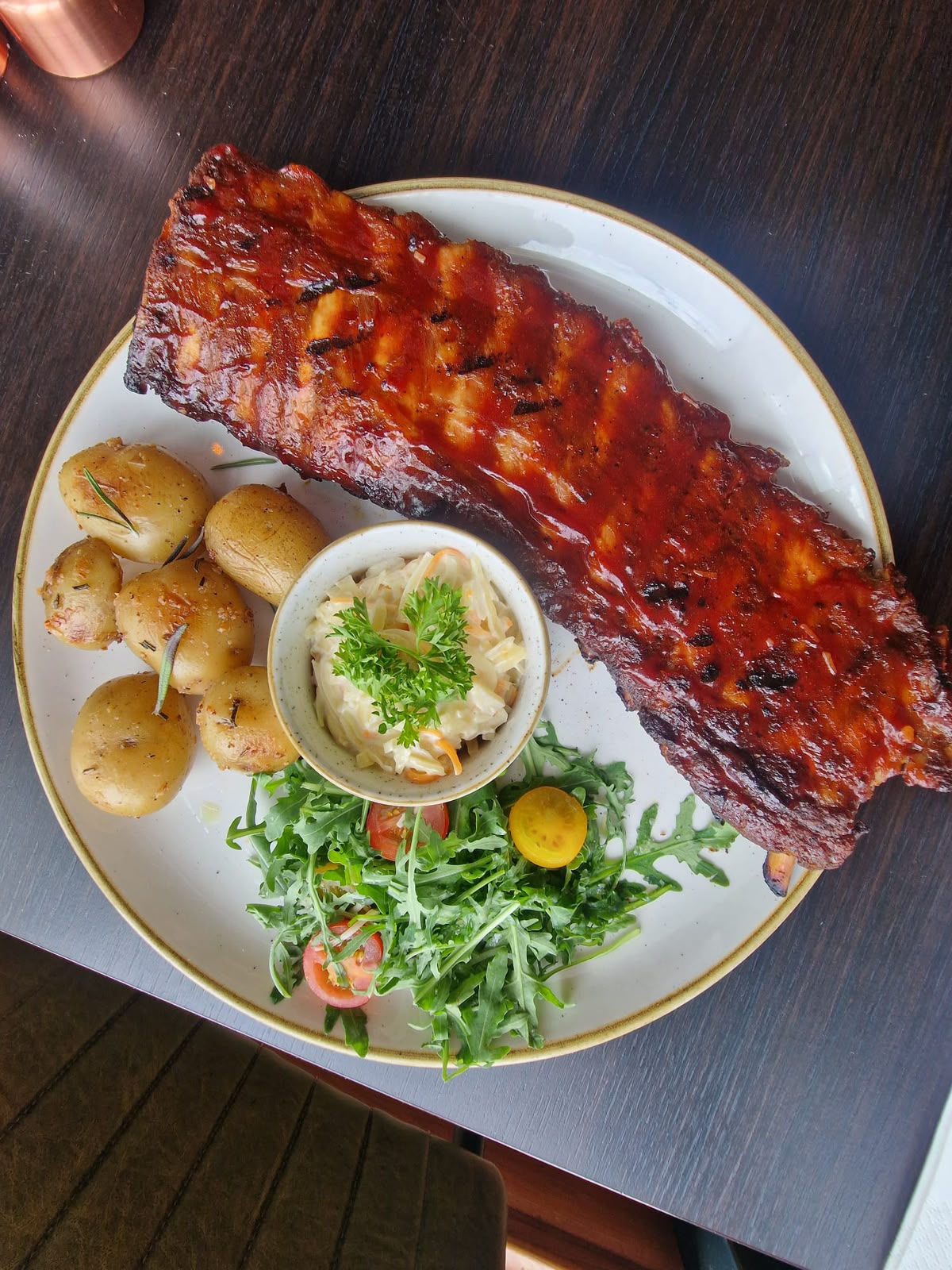 Full rack of sticky BBQ ribs with rosemary roast potatoes and slaw